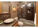 Modern bathroom with vessel sink, glass enclosed tub shower combination and decorative tile backsplash at 23014 N 52Nd St, Phoenix, AZ 85054