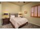 Serene bedroom featuring natural light from the window with stylish shutters, creating a calm atmosphere at 23014 N 52Nd St, Phoenix, AZ 85054