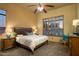Comfortable bedroom featuring a ceiling fan and large window with stylish shutters for natural light at 23014 N 52Nd St, Phoenix, AZ 85054