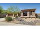 Charming home exterior with desert landscaping and a decorative rock stream feature at 23014 N 52Nd St, Phoenix, AZ 85054