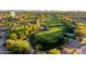 Expansive aerial view of a lush golf course showcasing manicured greens and surrounding desert landscaping, perfect for golf enthusiasts at 23014 N 52Nd St, Phoenix, AZ 85054