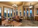 Open living area with leather seating, accent rugs, and views of the outdoor patio and desert landscape at 23014 N 52Nd St, Phoenix, AZ 85054