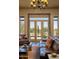 Warm living area with leather seating and a picturesque view of the outdoor pool and desert landscape at 23014 N 52Nd St, Phoenix, AZ 85054