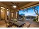 Covered patio with an outdoor dining set, ceiling fan, and views of the pool at 23014 N 52Nd St, Phoenix, AZ 85054