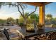 Outdoor patio features seating, stone flooring, and views of the pool and desert landscape at 23014 N 52Nd St, Phoenix, AZ 85054