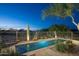 Inviting pool area showcasing desert landscaping and mature trees, creating a private and serene outdoor space at 23014 N 52Nd St, Phoenix, AZ 85054