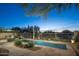 Inviting pool area showcasing desert landscaping and mature trees, creating a private and serene outdoor space at 23014 N 52Nd St, Phoenix, AZ 85054
