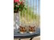 Close up of patio table with 19th Hole glasses and flowering plant on a sunny day at 23014 N 52Nd St, Phoenix, AZ 85054