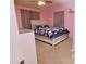 Bedroom with neutral walls, a ceiling fan, and blue floral bedding, creating a peaceful atmosphere at 2305 E Southern Ave, Phoenix, AZ 85040