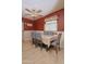 Inviting dining room with gray chairs, light tile flooring, and a contemporary ceiling fan for comfortable living at 2305 E Southern Ave, Phoenix, AZ 85040