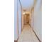 Hallway with tile flooring, clean white walls, and multiple doors for a smooth transition from one space to another at 2305 E Southern Ave, Phoenix, AZ 85040