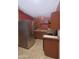 Efficient kitchen featuring stainless steel appliances, granite countertops, and wooden cabinetry for storage at 2305 E Southern Ave, Phoenix, AZ 85040