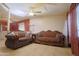 Open-concept living room featuring tile flooring, neutral paint, and classic couches that offer a cozy space at 2305 E Southern Ave, Phoenix, AZ 85040