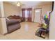 Open living room featuring tile floors, neutral walls, and a white front door for an inviting space at 2305 E Southern Ave, Phoenix, AZ 85040