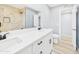 Bathroom with double sink vanity with drawers, quartz countertop, and tub/shower combo at 2628 W Marshall Ave, Phoenix, AZ 85017