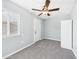 Bedroom showcasing new carpet, ceiling fan, fresh paint, and a bright window at 2628 W Marshall Ave, Phoenix, AZ 85017