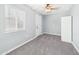 Neutral bedroom with new carpet, fresh paint, ceiling fan, and a bright window at 2628 W Marshall Ave, Phoenix, AZ 85017