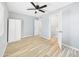 Spacious bedroom with light-colored wood floors, white closet, and ensuite bathroom at 2628 W Marshall Ave, Phoenix, AZ 85017