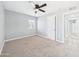 Bright bedroom featuring neutral carpet, modern ceiling fan, and natural light from window at 2628 W Marshall Ave, Phoenix, AZ 85017