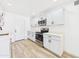 Modern kitchen with white cabinets, stainless steel appliances, and stylish flooring at 2628 W Marshall Ave, Phoenix, AZ 85017