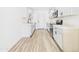 Kitchen featuring new white cabinets, modern appliances, sleek countertops, and stylish flooring at 2628 W Marshall Ave, Phoenix, AZ 85017