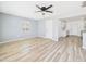 Bright living room featuring new flooring, fresh paint, modern ceiling fan, and a view into the kitchen at 2628 W Marshall Ave, Phoenix, AZ 85017