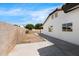 A spacious backyard with a long concrete patio and a block wall fence offers privacy at 2640 E Mallory St, Mesa, AZ 85213