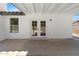 View of the backyard patio area of a home, with white walls and french doors at 2640 E Mallory St, Mesa, AZ 85213