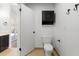 Half bathroom featuring a toilet, tile flooring, and a door to the backyard at 2640 E Mallory St, Mesa, AZ 85213
