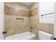 Well-lit bathroom boasting a tiled shower and bathtub with a decorative tile accent and a modern toilet at 2640 E Mallory St, Mesa, AZ 85213