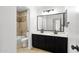 Bathroom featuring double sinks, bathtub with shower, and neutral tile flooring at 2640 E Mallory St, Mesa, AZ 85213