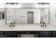 Bathroom featuring double sinks, large mirror, neutral paint and dark cabinets at 2640 E Mallory St, Mesa, AZ 85213