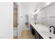 Bathroom with a double sink, large mirror and diagonally tiled floor at 2640 E Mallory St, Mesa, AZ 85213
