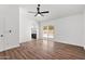 Open bedroom with wood-look floors, a ceiling fan, and access to the backyard pool at 2640 E Mallory St, Mesa, AZ 85213