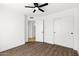 Bedroom featuring laminate flooring, a doorway, and a sliding-door closet at 2640 E Mallory St, Mesa, AZ 85213