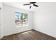 Bright bedroom showcasing laminate flooring and a window offering neighborhood views at 2640 E Mallory St, Mesa, AZ 85213