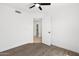 Bright bedroom featuring wood-look floors, neutral walls, and ceiling fan at 2640 E Mallory St, Mesa, AZ 85213