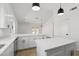 Modern kitchen with white cabinetry, double islands and breakfast bar seating at 2640 E Mallory St, Mesa, AZ 85213