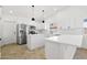 Modern kitchen boasts white cabinets, stainless steel appliances and large island at 2640 E Mallory St, Mesa, AZ 85213