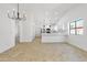 Bright, open living area with updated chandelier and easy access to the kitchen at 2640 E Mallory St, Mesa, AZ 85213