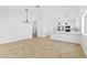 Open-concept living area with updated tile floors, neutral paint and adjacent to kitchen at 2640 E Mallory St, Mesa, AZ 85213