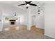 Open living space featuring a fireplace, ceiling fans, and a blend of tile and carpet flooring at 2640 E Mallory St, Mesa, AZ 85213