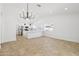 Open-concept living space with kitchen, breakfast bar, tile floors and modern chandelier at 2640 E Mallory St, Mesa, AZ 85213