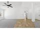 Spacious living room with tile and carpet, ceiling fan, and bright natural light at 2640 E Mallory St, Mesa, AZ 85213