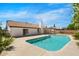 Backyard oasis featuring a sparkling blue pool, covered patio, and lush landscaping at 2640 E Mallory St, Mesa, AZ 85213