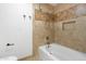 Tiled shower featuring neutral colored tiles and a shower/tub combo at 2640 E Mallory St, Mesa, AZ 85213