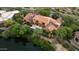 An aerial view of a stately residence with a pond and mature landscaping, offering privacy and scenic views at 27050 N 103Rd St, Scottsdale, AZ 85262
