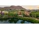 Scenic aerial view of lakeside home showcasing tile roof and mature landscaping at 27050 N 103Rd St, Scottsdale, AZ 85262