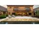 Backyard features a patio with lounge seating, pool, and stunning architectural details at 27050 N 103Rd St, Scottsdale, AZ 85262