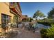 Backyard features a patio with lounge seating, pool, and stunning trees at 27050 N 103Rd St, Scottsdale, AZ 85262
